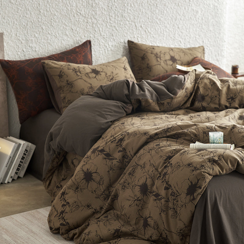 Brown cotton bedding with black botanical motifs.