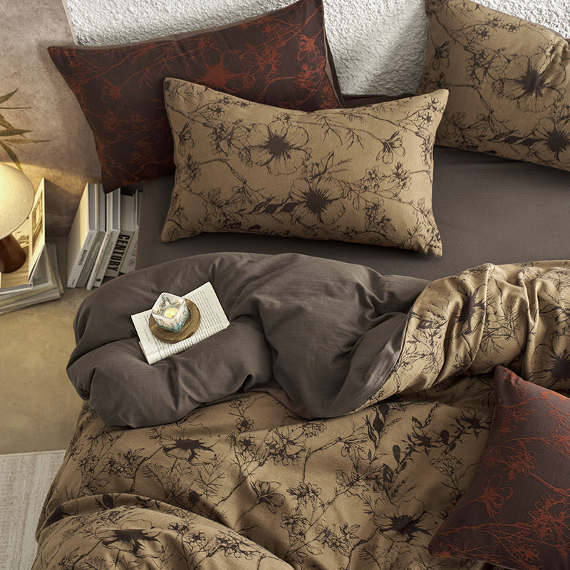 Brown cotton bedding with black botanical motifs.