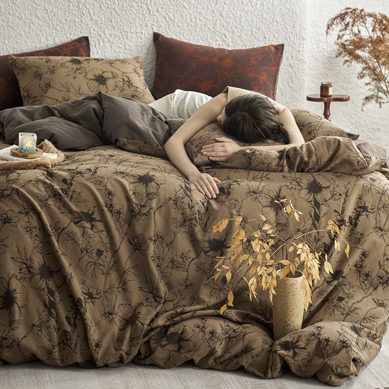Brown cotton bedding with black botanical motifs.