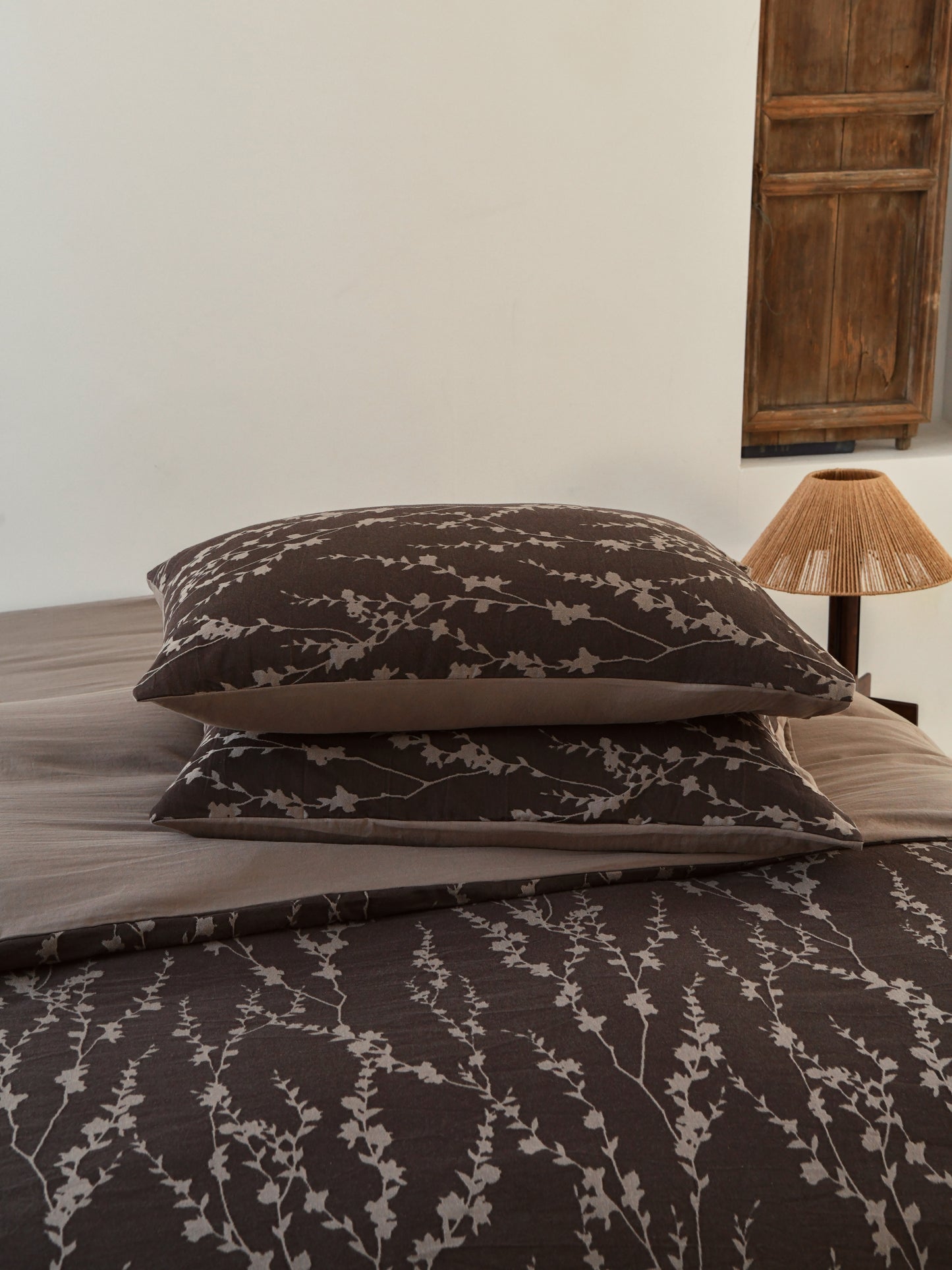 Taupe vine bedding set featuring elegant vine patterns on pillows and sheets, enhancing organic sophistication in bedroom decor.