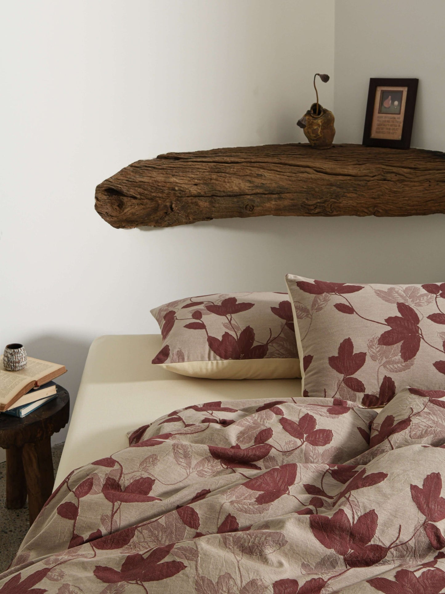 Neutral beige duvet with red botanical leaf design in breathable cotton.