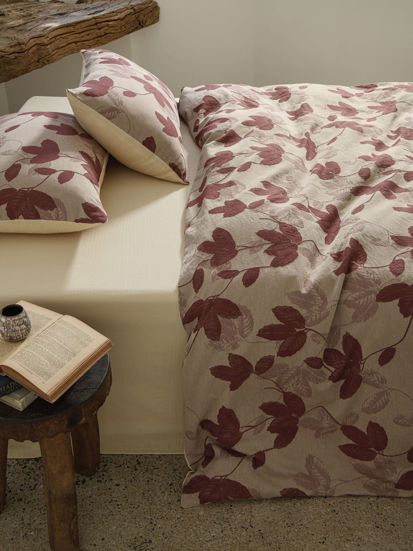 Neutral beige duvet with red botanical leaf design in breathable cotton.