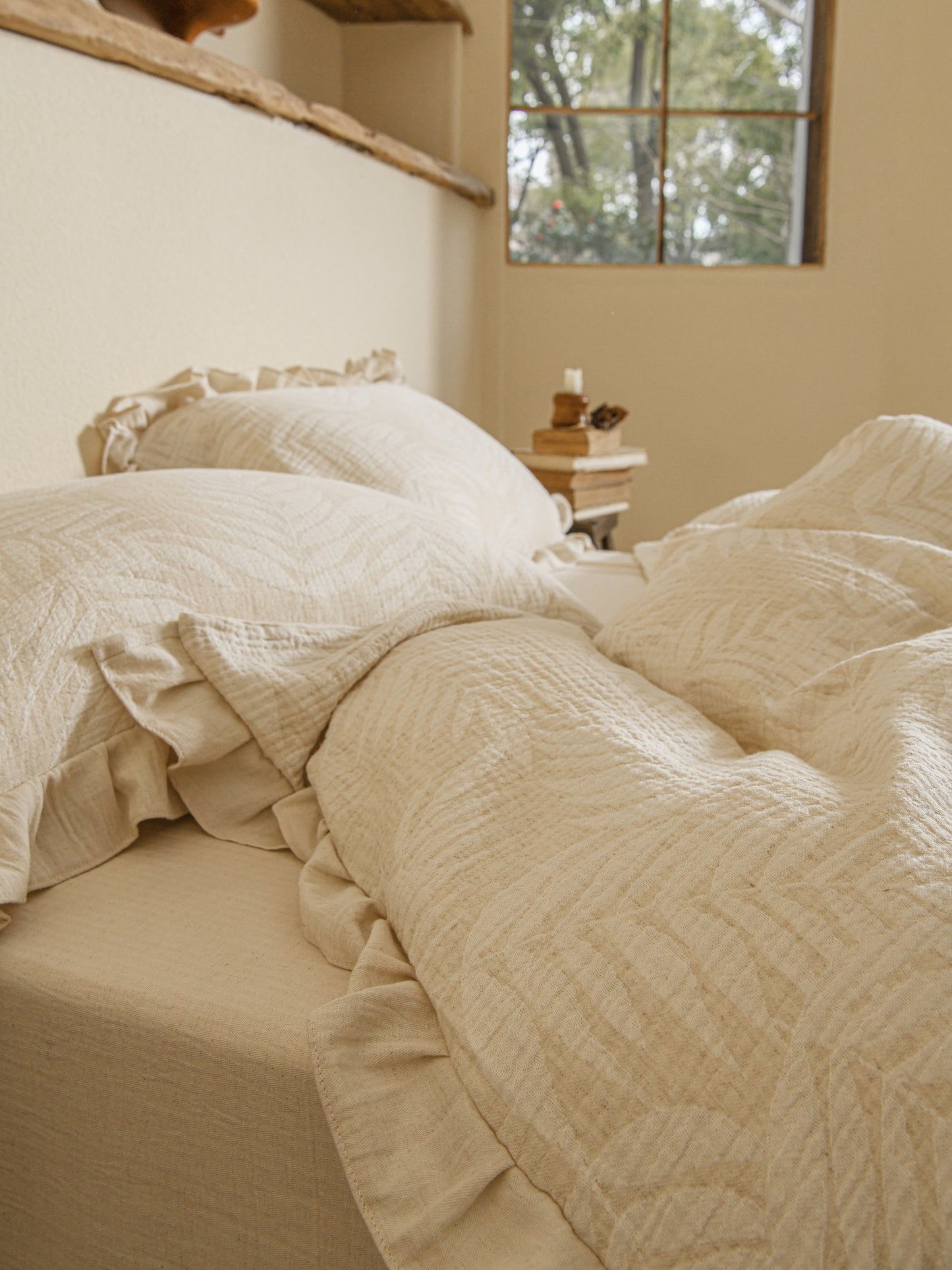 Neutral beige linen duvet with tonal floral embroidery.