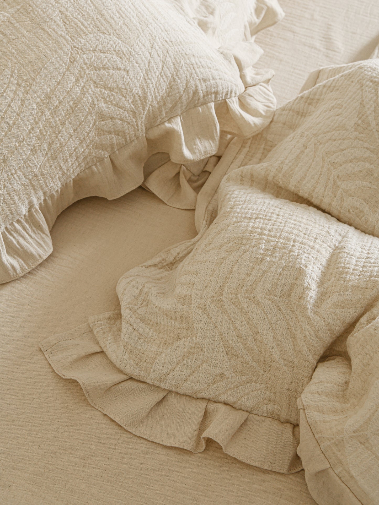 Neutral beige linen duvet with tonal floral embroidery.