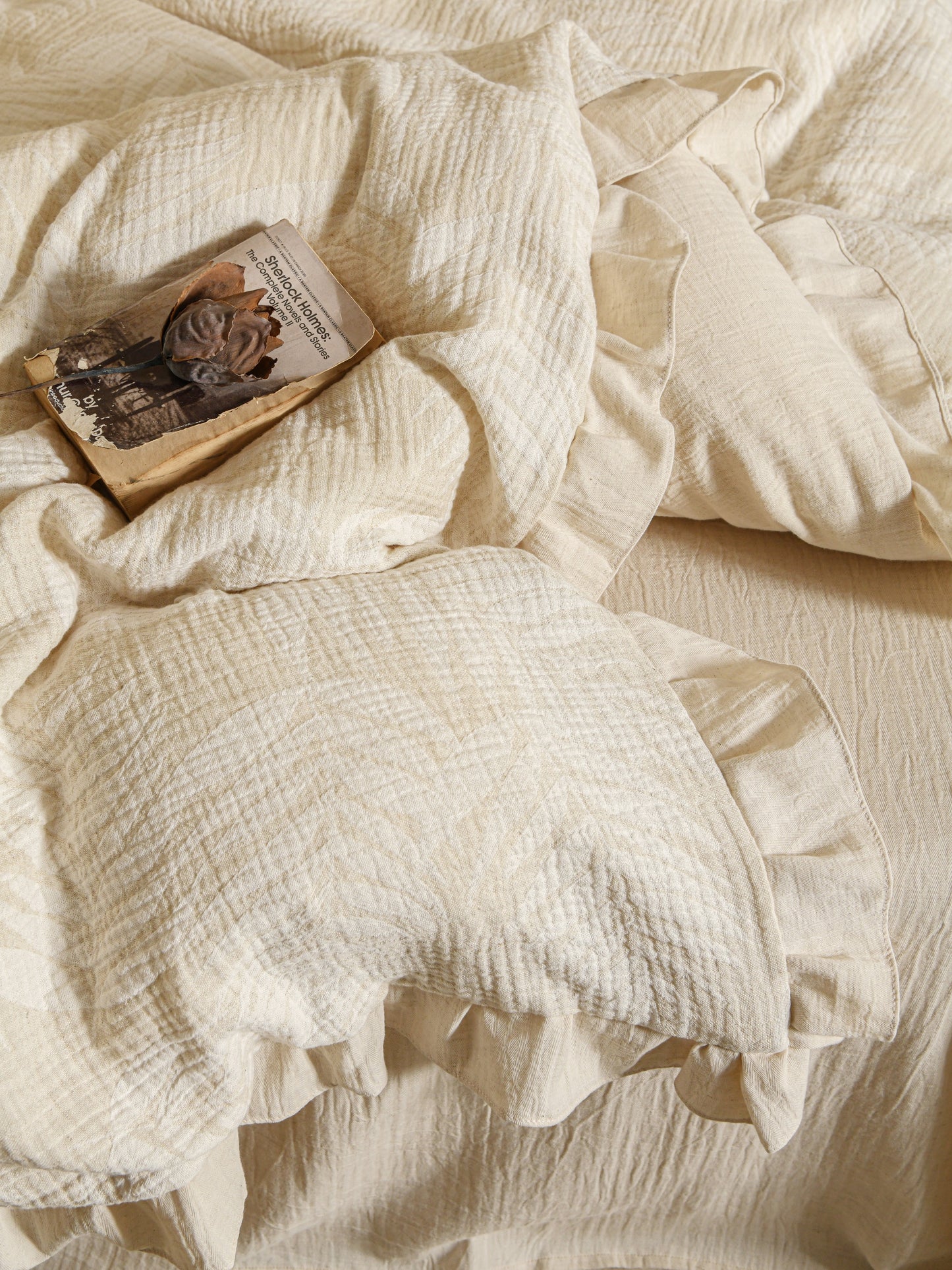 Neutral beige linen duvet with tonal floral embroidery.