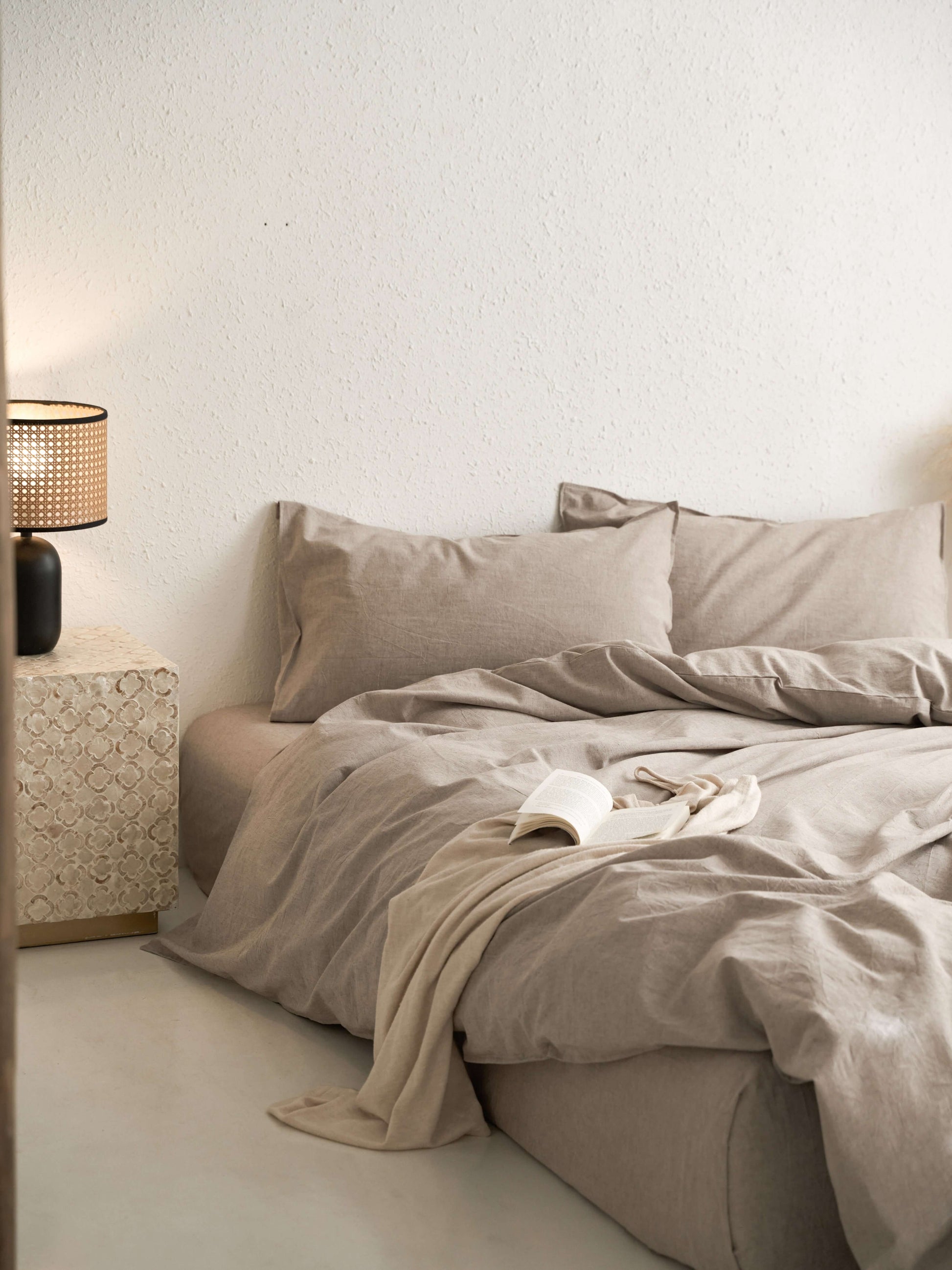 Neutral latte linen bedding with natural textured weave.