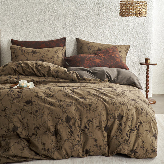 Brown cotton bedding with black botanical motifs.