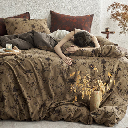 Brown cotton bedding with black botanical motifs.