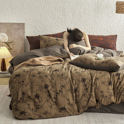 Brown cotton bedding with black botanical motifs.