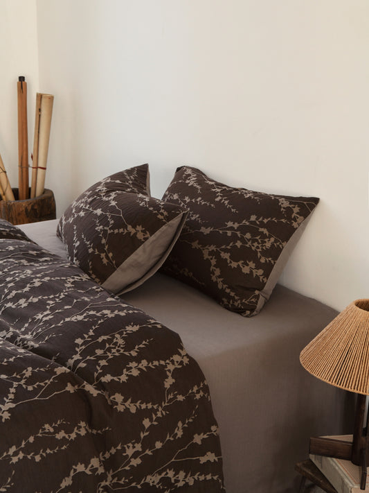 Taupe vine bedding set featuring elegant leaf patterns, enhancing a cozy bedroom atmosphere with organic sophistication.