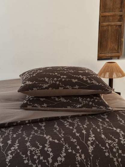 Taupe vine bedding set featuring elegant vine patterns on pillows and sheets, enhancing organic sophistication in bedroom decor.