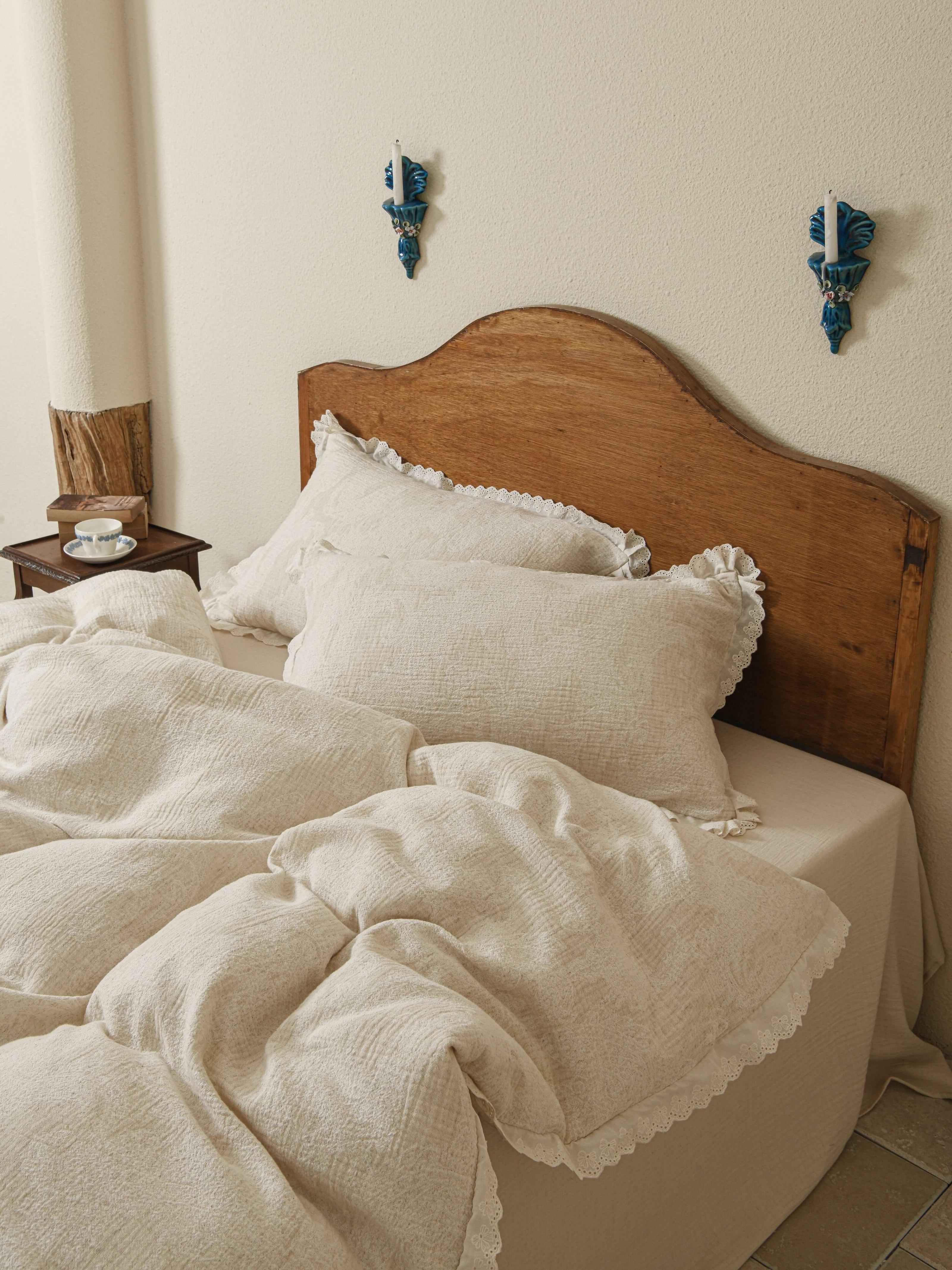 Neutral beige floral quilt with subtle lace accents in premium linen.