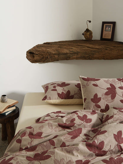 Neutral beige duvet with red botanical leaf design in breathable cotton.