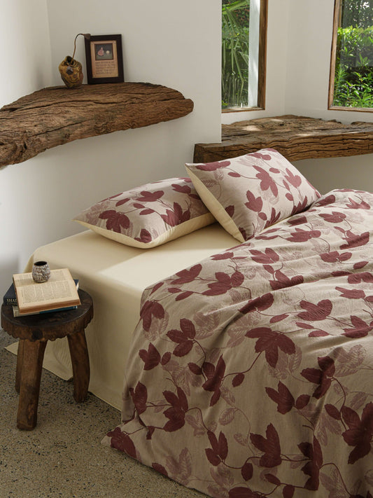 Neutral beige duvet with red botanical leaf design in breathable cotton.