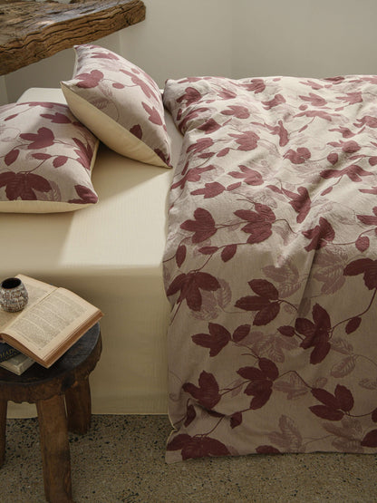 Neutral beige duvet with red botanical leaf design in breathable cotton.