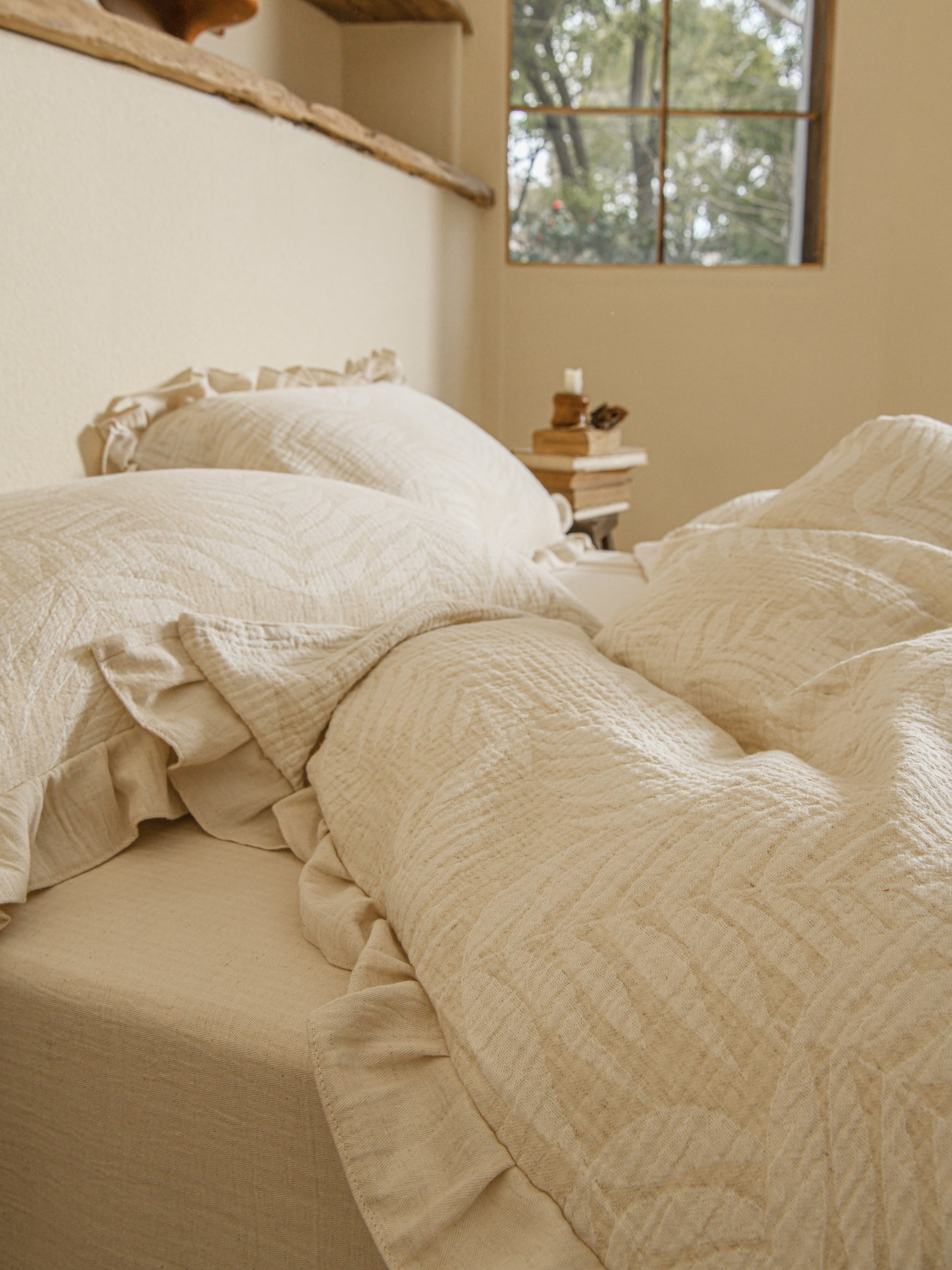 Neutral beige linen duvet with tonal floral embroidery.
