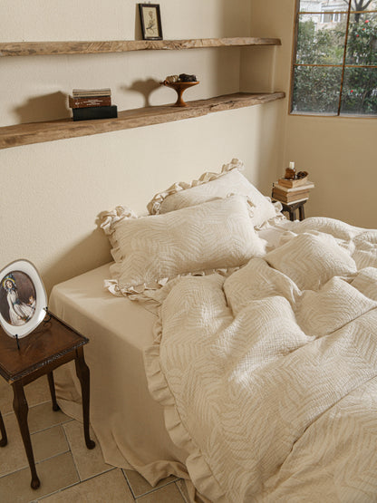 Neutral beige linen duvet with tonal floral embroidery.