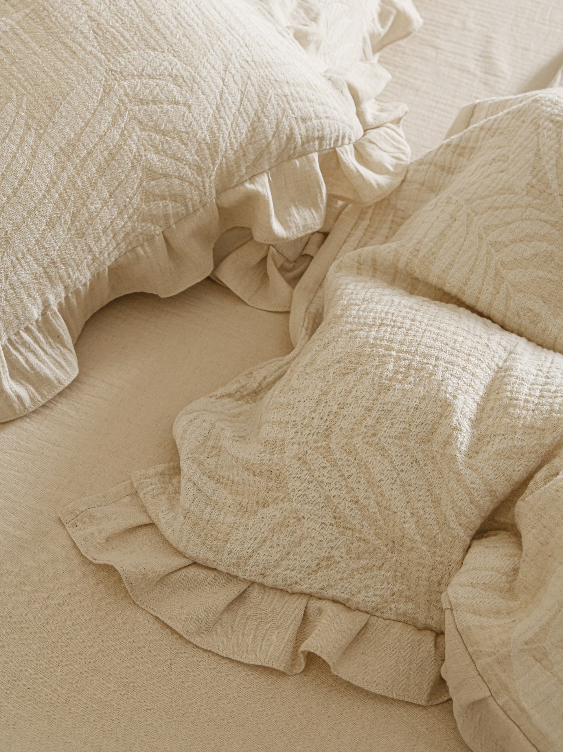 Neutral beige linen duvet with tonal floral embroidery.