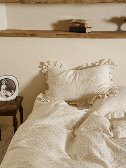 Neutral beige linen duvet with tonal floral embroidery.